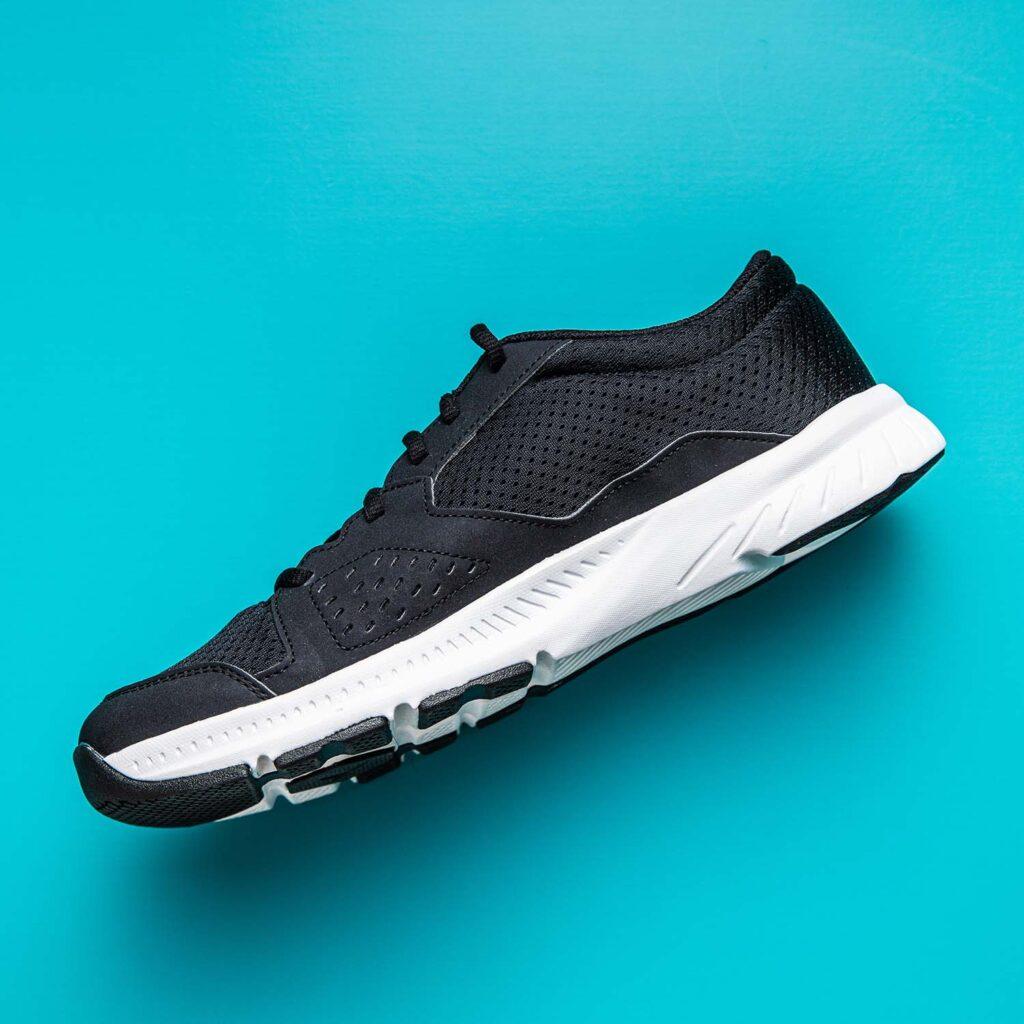 Athletic sneakers displayed clean with bubbles highlighting sports shoe cleaning.